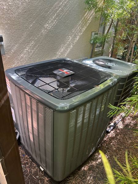 New split-system condensing unit installed beside a home